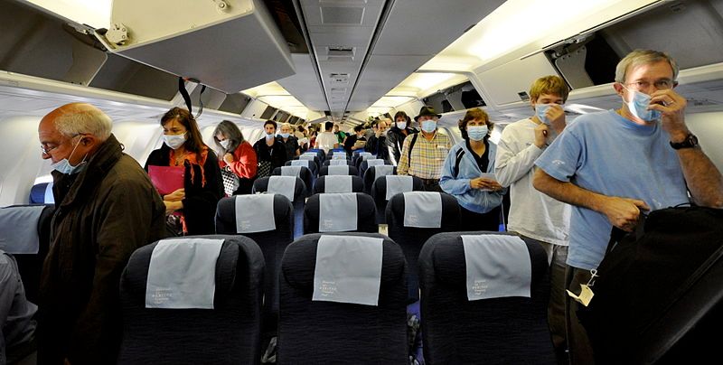 A group of airline passengers wearing masks during the Swine Flu outbreak. Photo: Roger Schultz