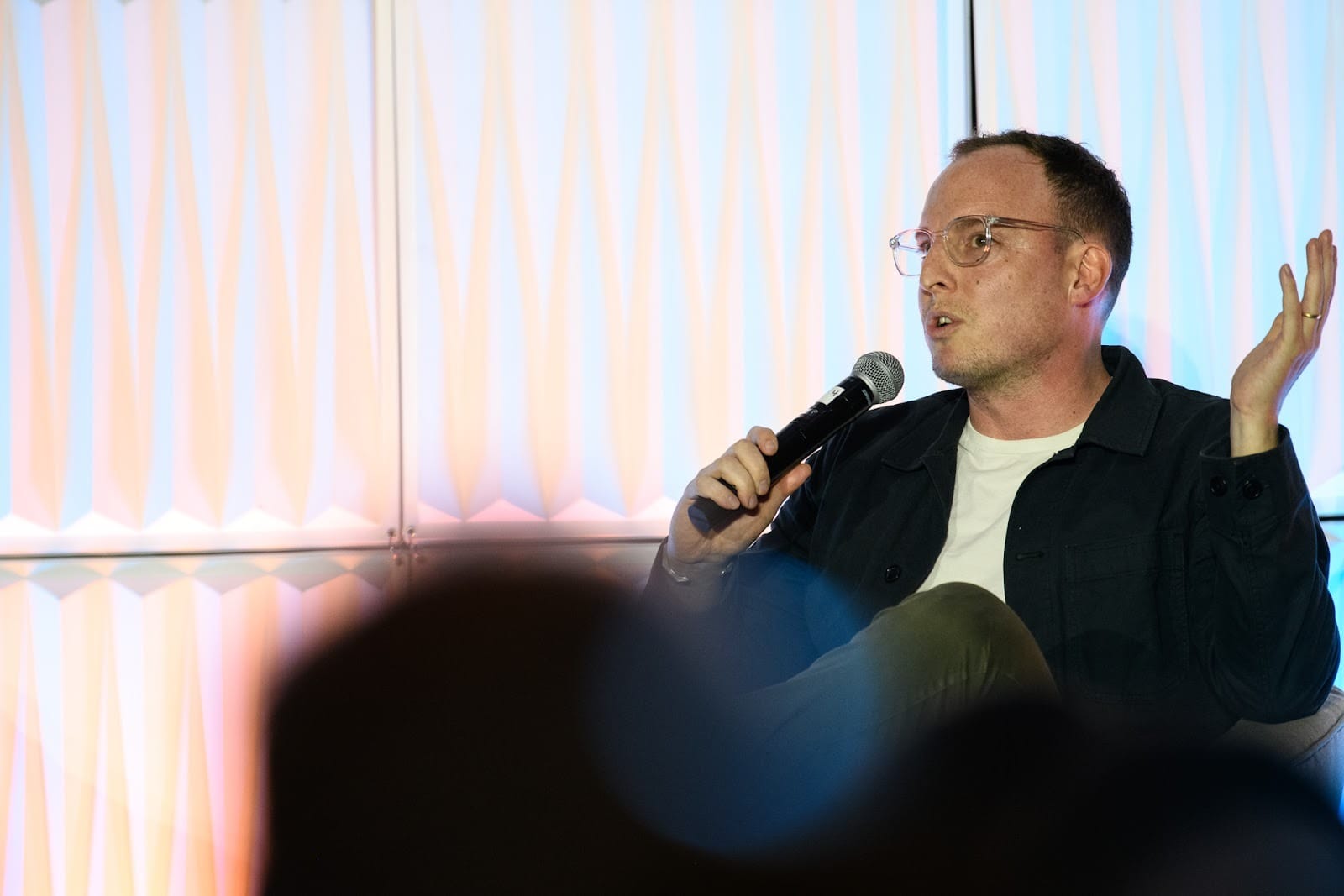 Isaac speaking on stage at the New Media Summit