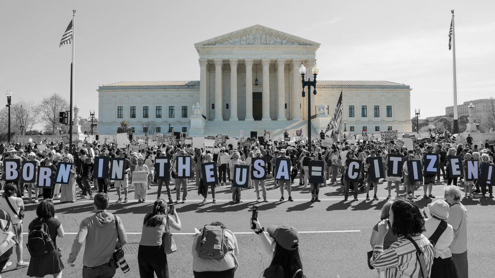 Demonstrators hold letters spelling out "Born in the USA = citizen!" in front of the Supreme Court during oral arguments on President Trump's executive order limiting birthright citizenship
