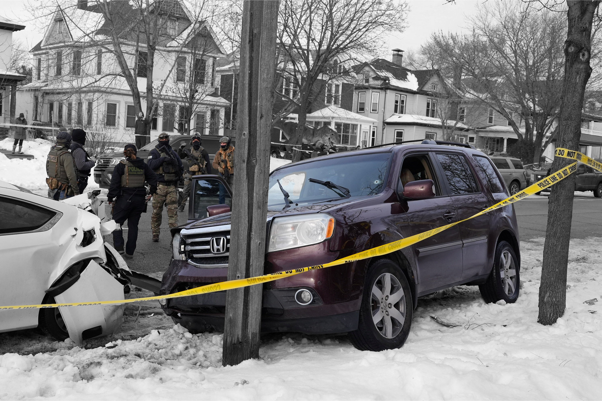 Federal agents next to a vehicle after its driver was shot by a U.S. immigration agent in Minneapolis, Minnesota | REUTERS/Tim Evans, edited by Russell Nystrom
